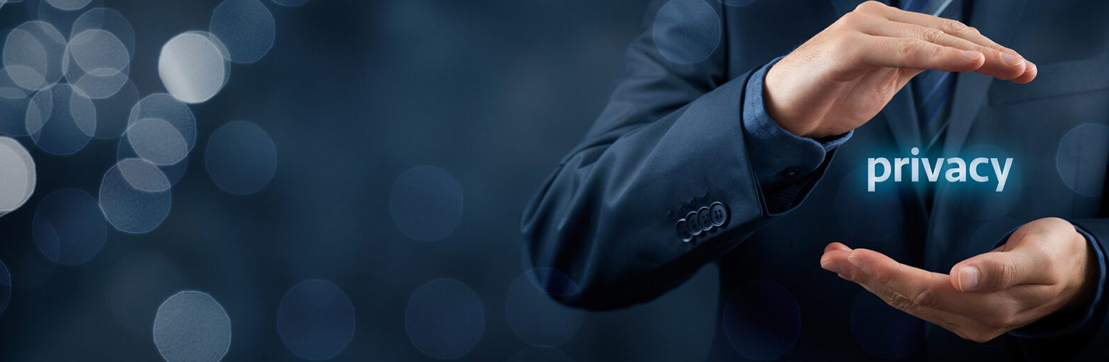 A businessman in a suit holds his hands in a protective gesture around the word 'privacy' against a dark, blurred background.