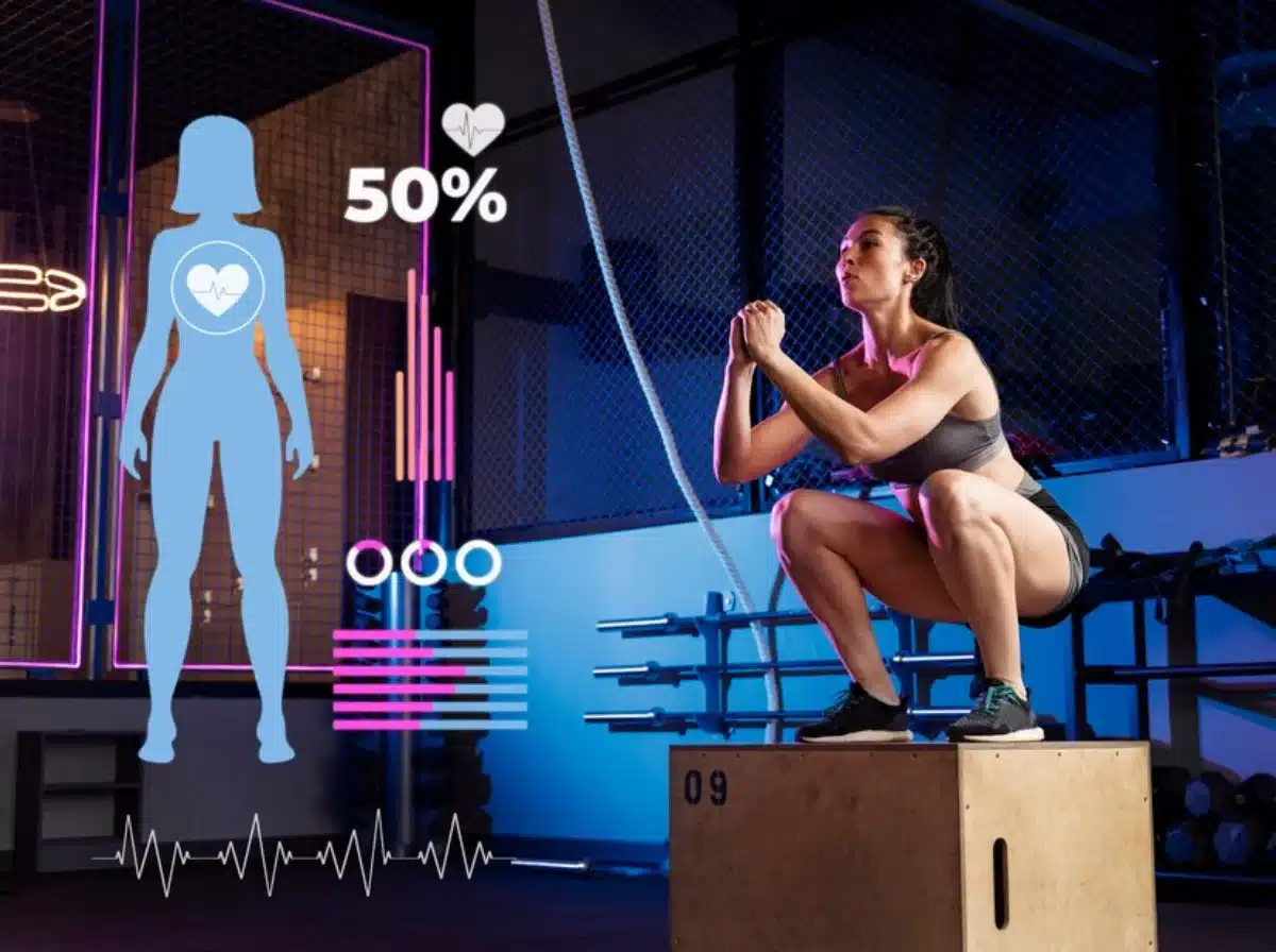Woman exercising in a gym with virtual fitness and health data graphics displayed next to her.